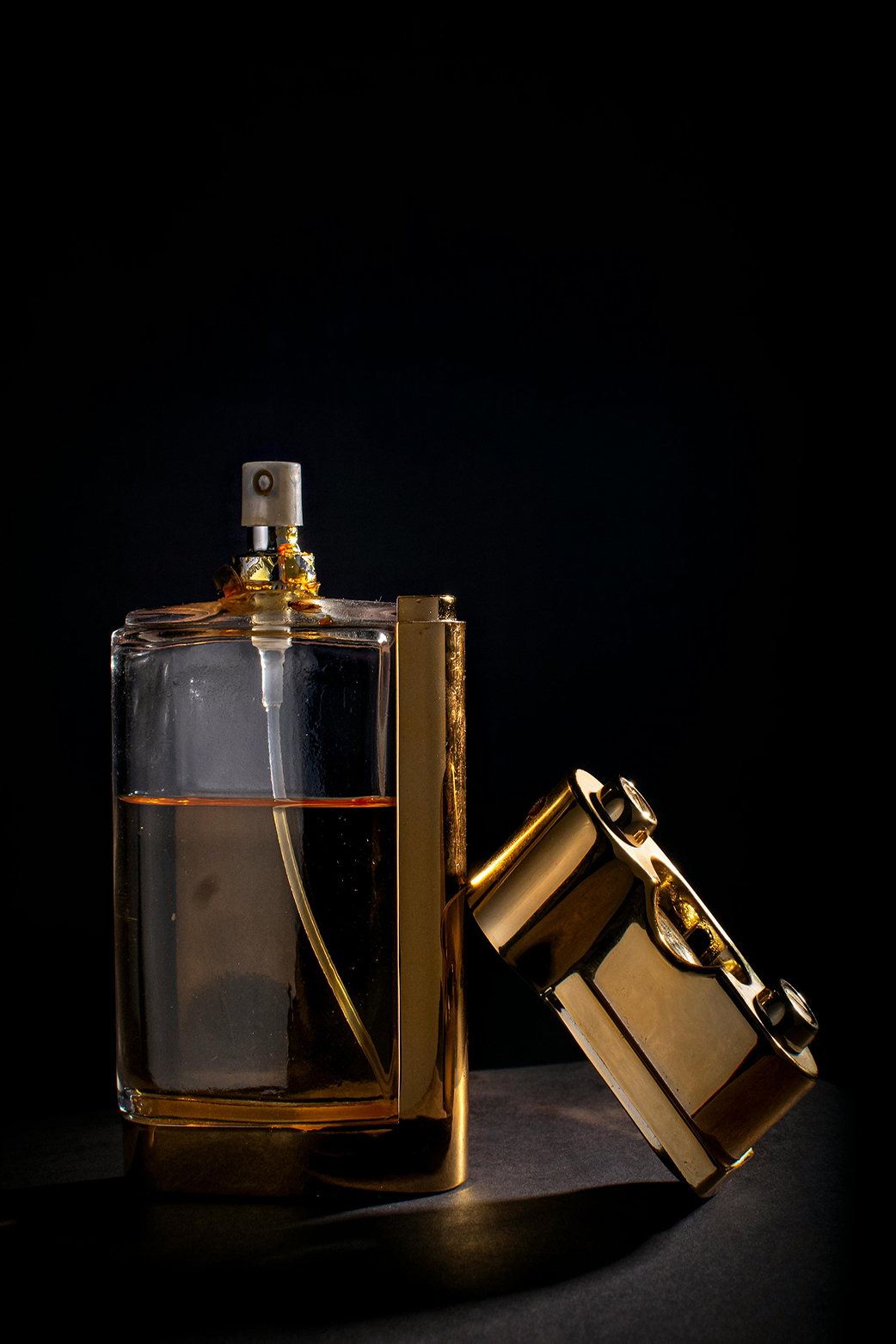 gold coloredperfume bottles on a dark background