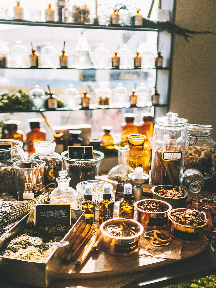 A perfume shop with perfume bottles and spices displayed on a table.